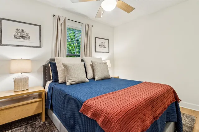 a bedroom with a bed and wooden floor