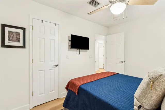 a bedroom with a bed and a flat screen tv
