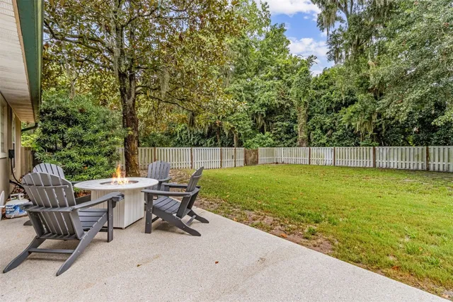 a view of backyard with seating and green space