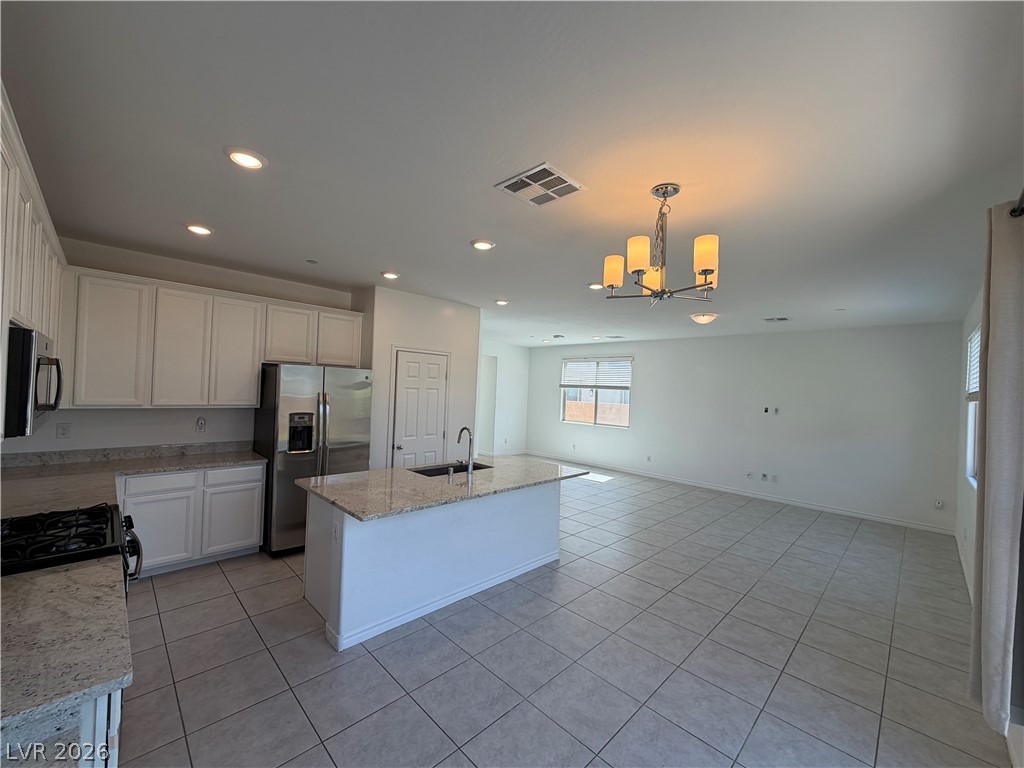 3228 Azalea Ridge Court Henderson, NV 89052 - Photo 5 of 28 An open concept design seamlessly connects the kitchen and living areas, offering effortless entertaining.