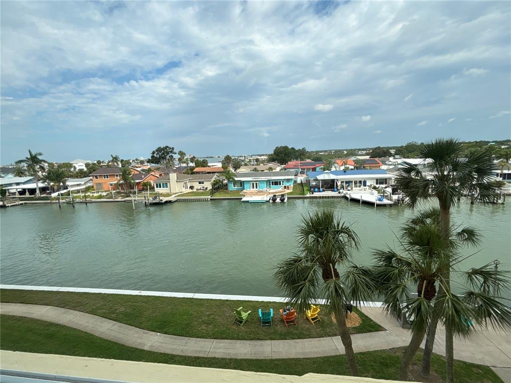 4725 Cove Circle, Unit 405 St. Petersburg, FL 33708 - Photo 23 of 23 a view of a lake with houses