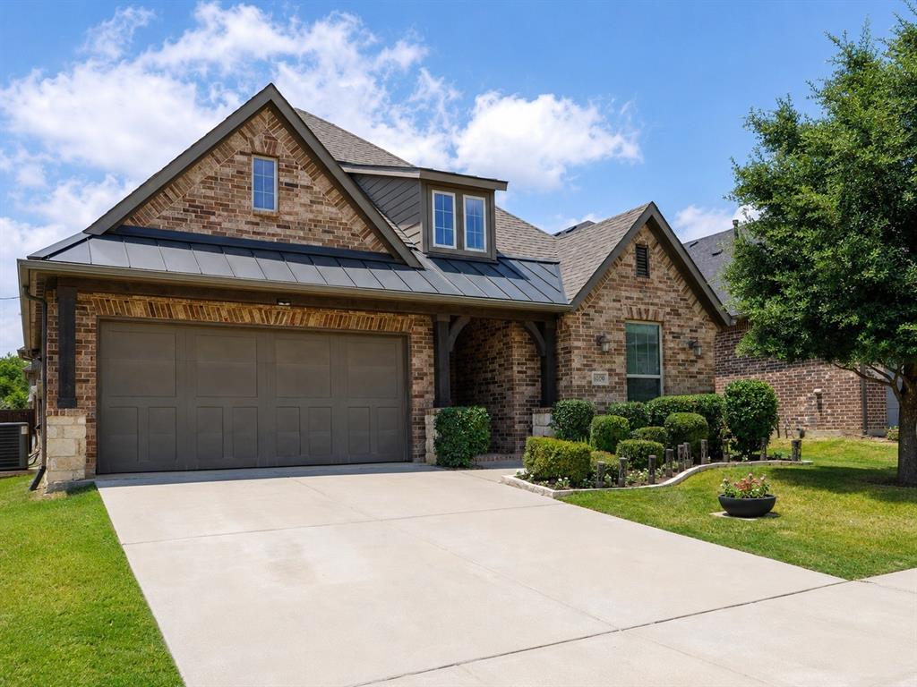 6209 Cupleaf Road Flower Mound, TX 76226 - Photo 3 of 29 Brick-clad exterior with a prominent two-car garage and a concrete driveway