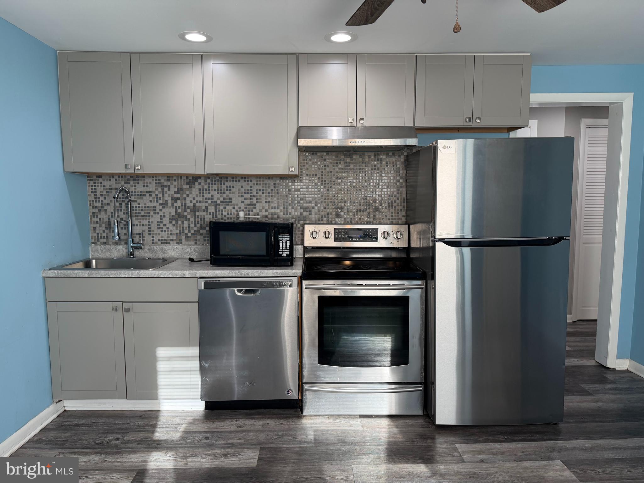 a kitchen with a refrigerator stove and microwave