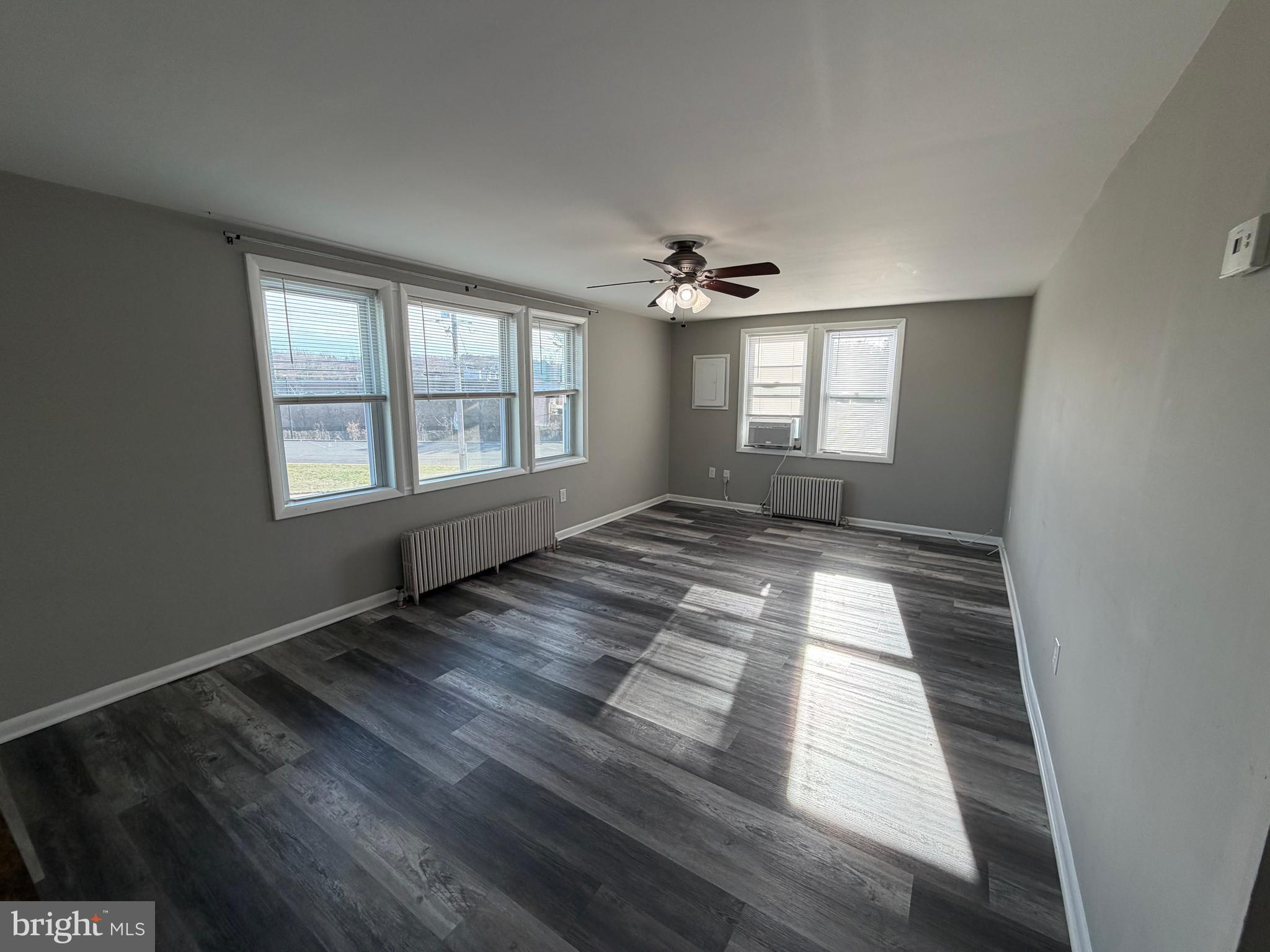 69 Berlin Road, Unit B Clementon, NJ 08021 - Photo 14 of 18 a view of empty room with wooden floor and fan