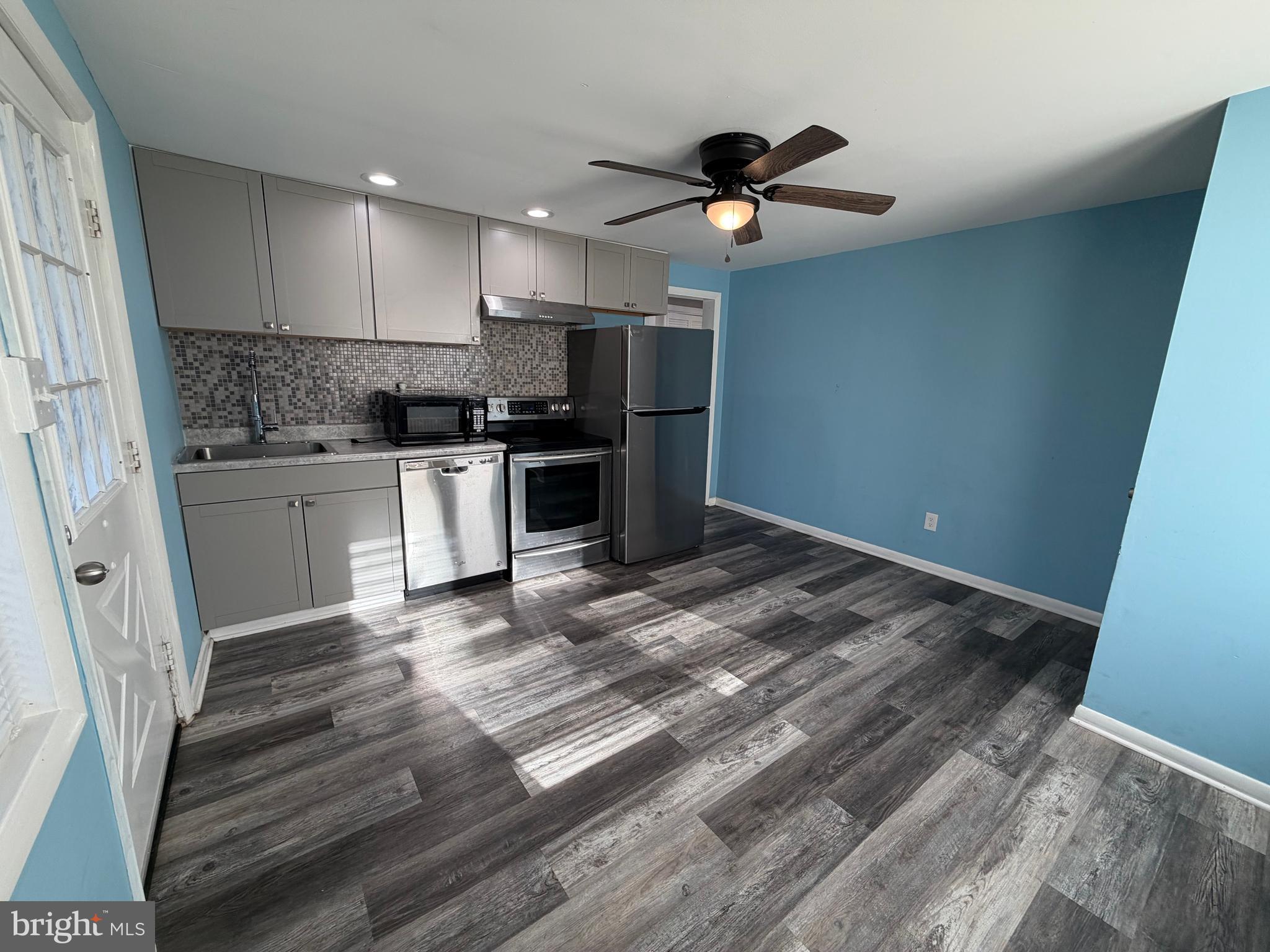 69 Berlin Road, Unit B Clementon, NJ 08021 - Photo 4 of 18 a kitchen with kitchen island a sink stainless steel appliances and cabinets