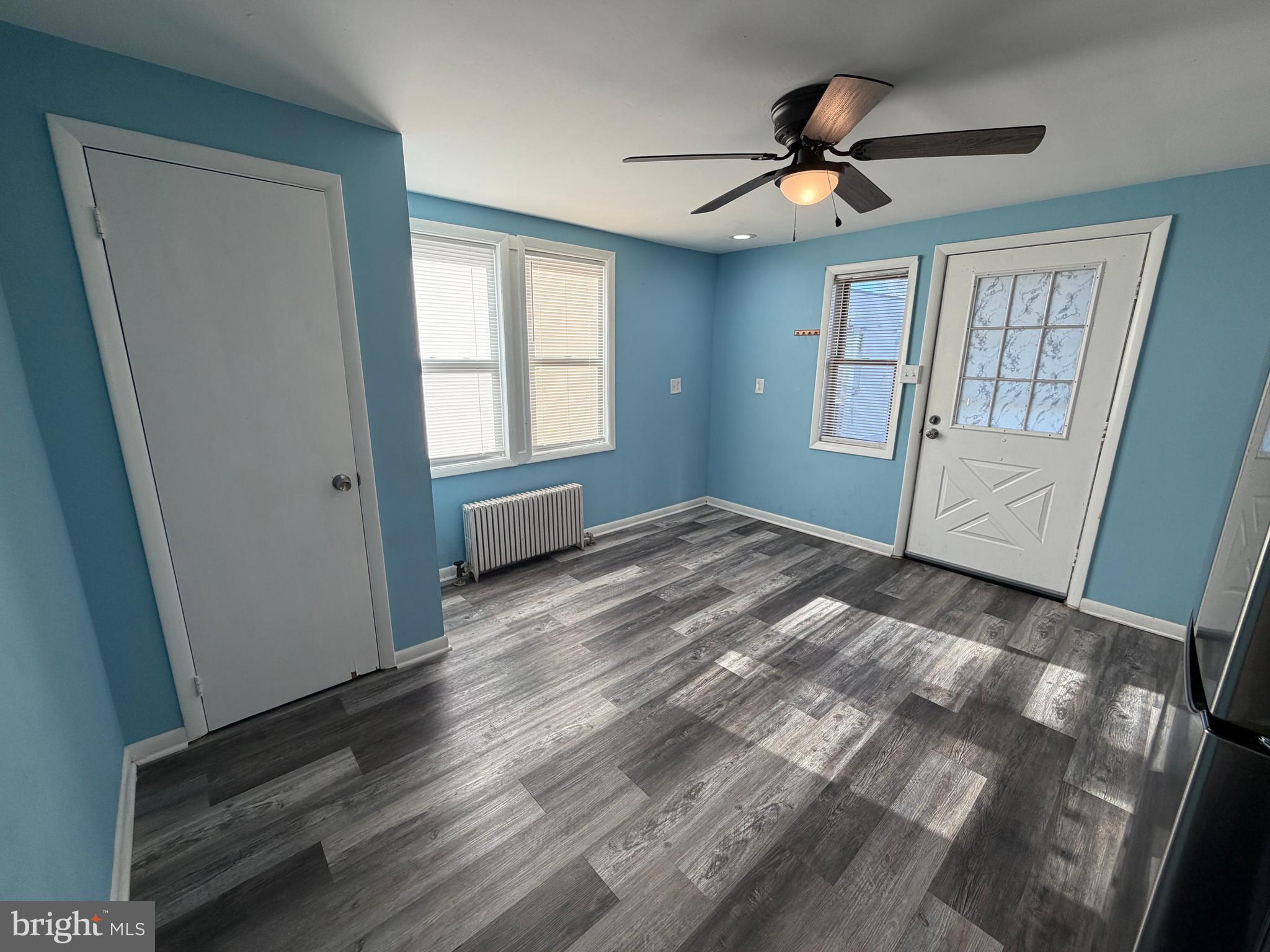 69 Berlin Road, Unit B Clementon, NJ 08021 - Photo 5 of 18 a view of empty room with wooden floor and fan