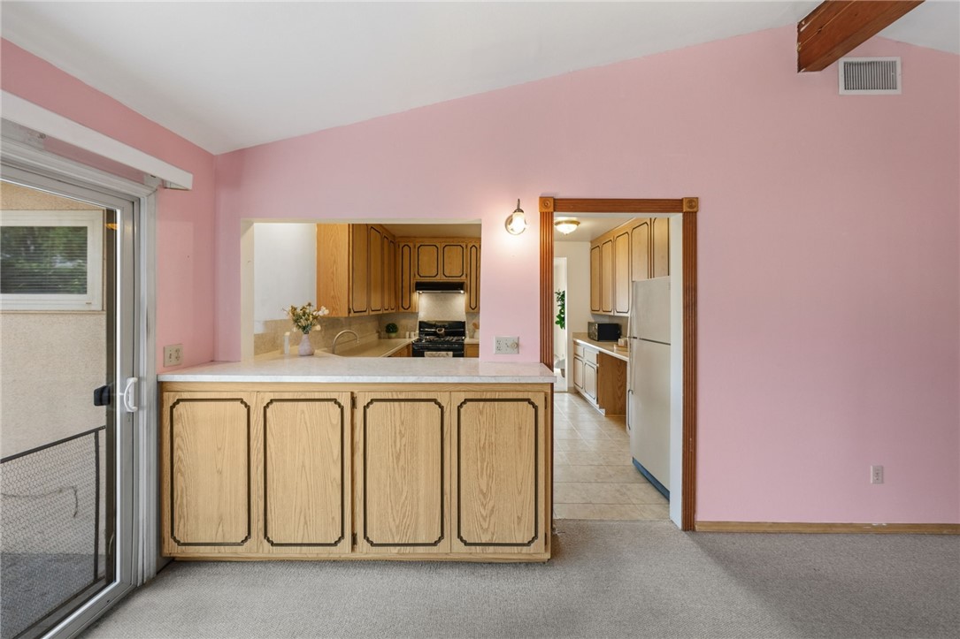 3075 David Street Riverside, CA 92506 - Photo 12 of 40 Dining space with a built-in breakfast bar/pass-through to the kitchen, creating an easy setup for serving and casual meals.