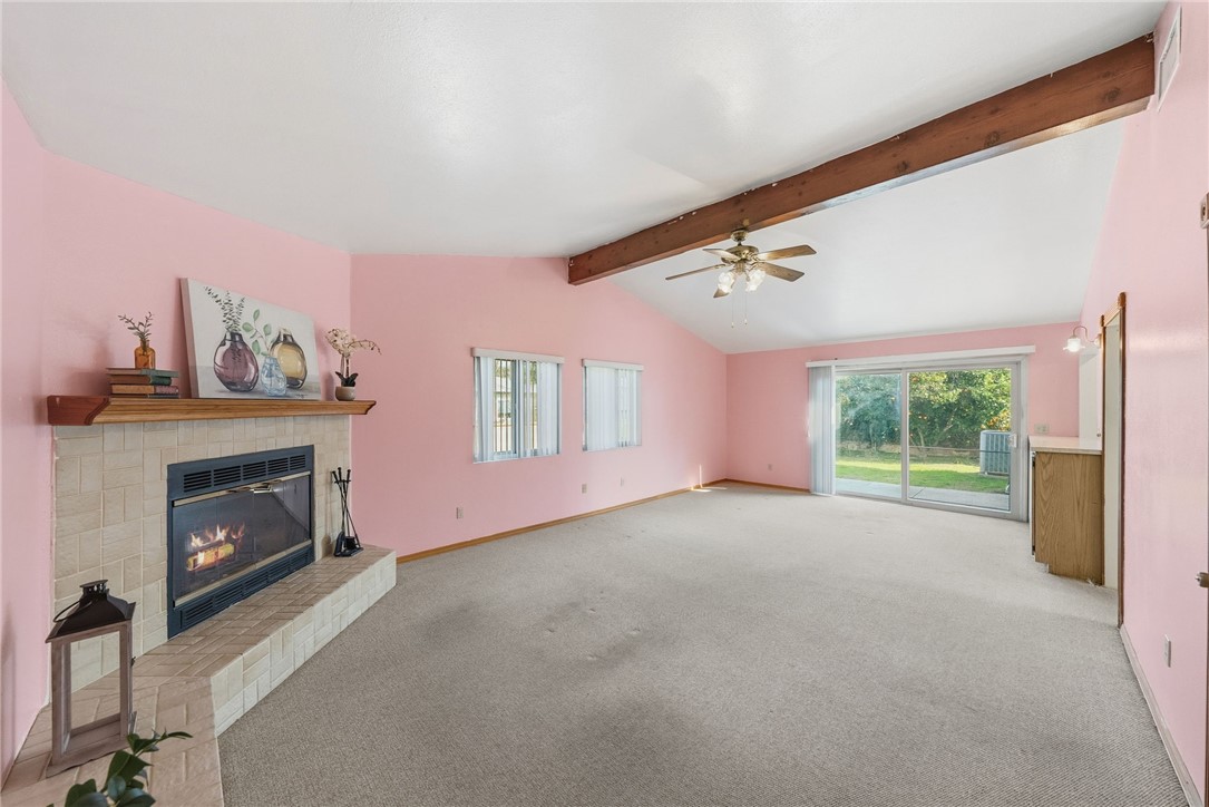 3075 David Street Riverside, CA 92506 - Photo 14 of 40 Large, light-filled room featuring a fireplace and sliding glass doors that open to the backyard—great for indoor-outdoor flow.