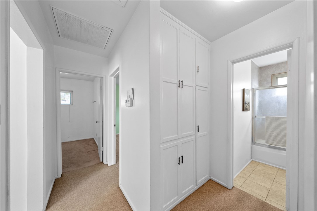 3075 David Street Riverside, CA 92506 - Photo 19 of 40 Hallway with built-in cabinetry for extra storage and a convenient connection to the bathroom and bedrooms.