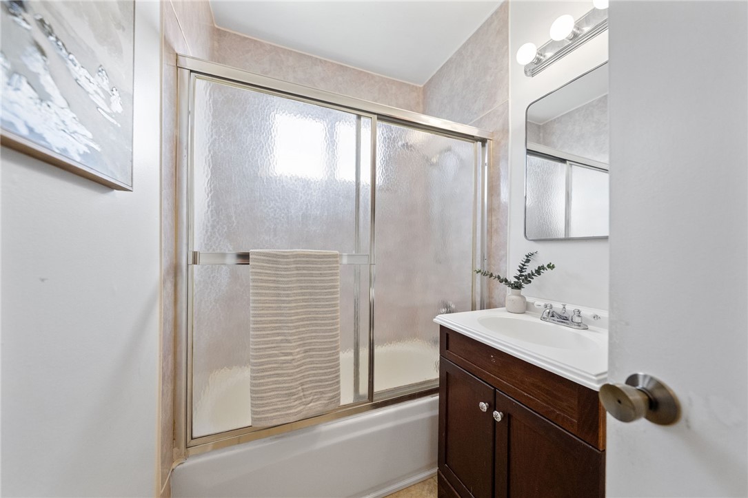 3075 David Street Riverside, CA 92506 - Photo 20 of 40 Full bath with tub/shower enclosure, updated vanity, and bright lighting for daily routines.