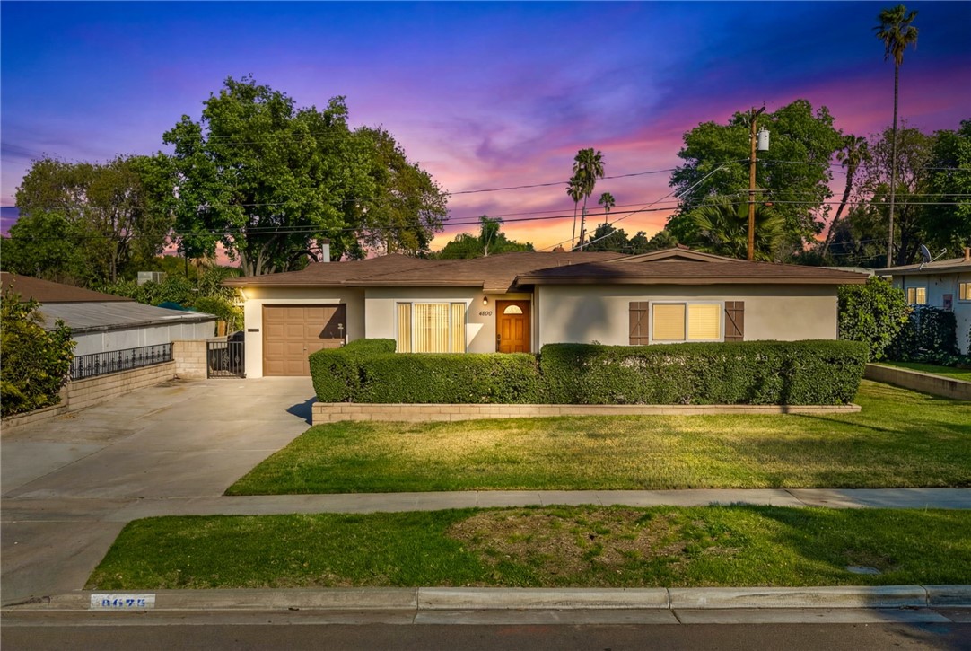 3075 David Street Riverside, CA 92506 - Photo 2 of 40 Evening view highlighting the home’s welcoming entry and landscaped front yard.