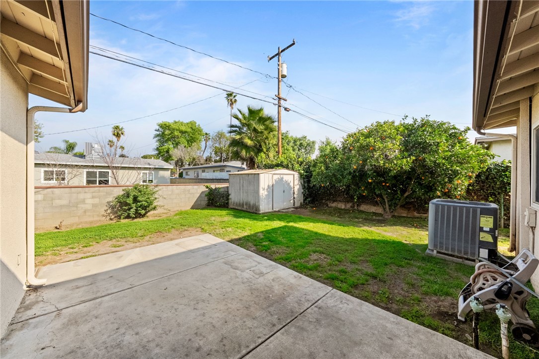3075 David Street Riverside, CA 92506 - Photo 27 of 40 Concrete patio opens to a grassy yard with a storage shed and mature landscaping for everyday outdoor enjoyment.
