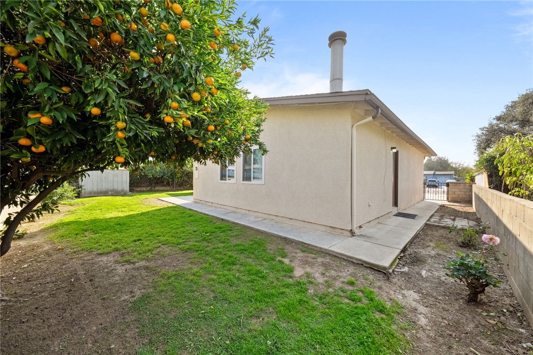 3075 David Street Riverside, CA 92506 - Photo 33 of 40 Concrete walkways wrap the home with additional yard space and easy access around the property.