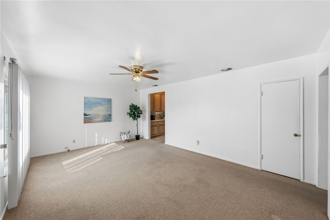 3075 David Street Riverside, CA 92506 - Photo 5 of 40 Expansive living space with a clean, neutral palette and easy access to the kitchen—ideal for everyday living and entertaining.
