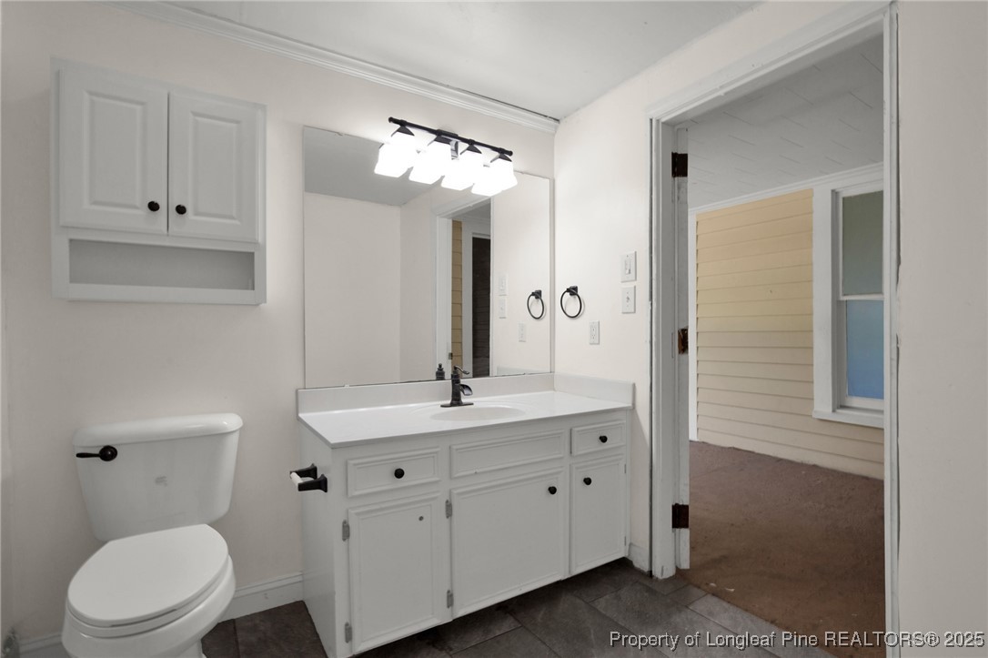 5125 Maxwell Road Autryville, NC 28318 - Photo 12 of 37 a bathroom with a toilet a sink and mirror