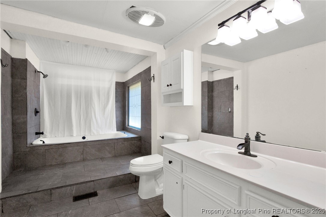 5125 Maxwell Road Autryville, NC 28318 - Photo 13 of 37 a bathroom with a double vanity sink mirror and toilet