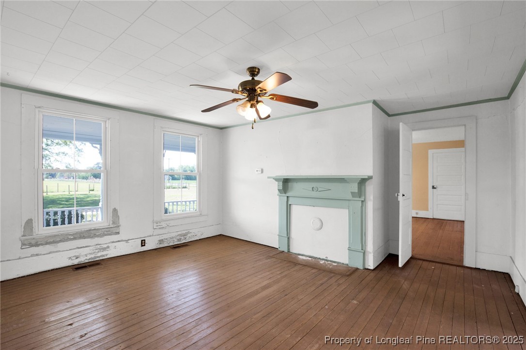 5125 Maxwell Road Autryville, NC 28318 - Photo 16 of 37 a view of an empty room with a window and wooden floor