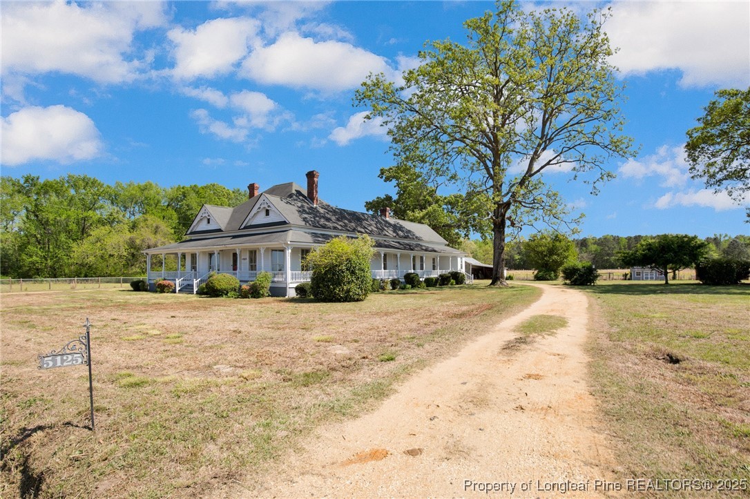 5125 Maxwell Road Autryville, NC 28318 - Photo 2 of 37 a front view of a house with a yard and mountain view in back