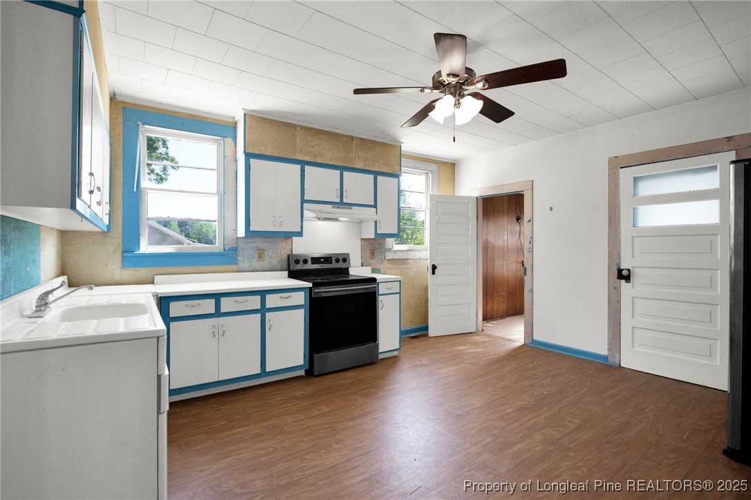 5125 Maxwell Road Autryville, NC 28318 - Photo 21 of 37 a kitchen with stainless steel appliances kitchen island granite countertop a sink cabinets and wooden floor