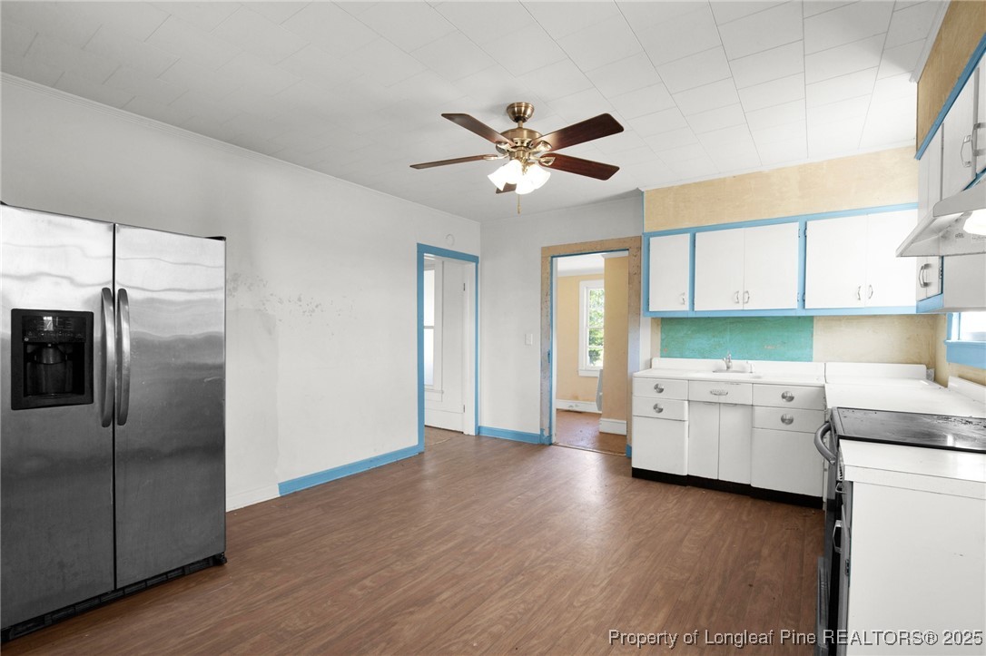 5125 Maxwell Road Autryville, NC 28318 - Photo 23 of 37 a kitchen with a refrigerator and white cabinets