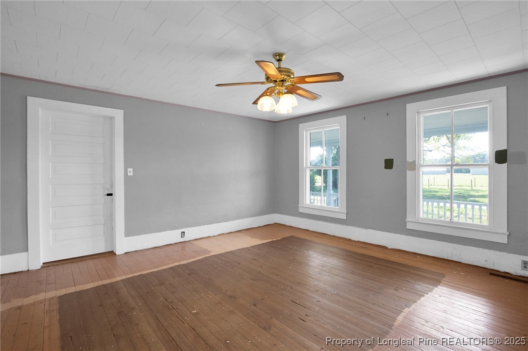 5125 Maxwell Road Autryville, NC 28318 - Photo 26 of 37 an empty room with windows and a chandelier fan