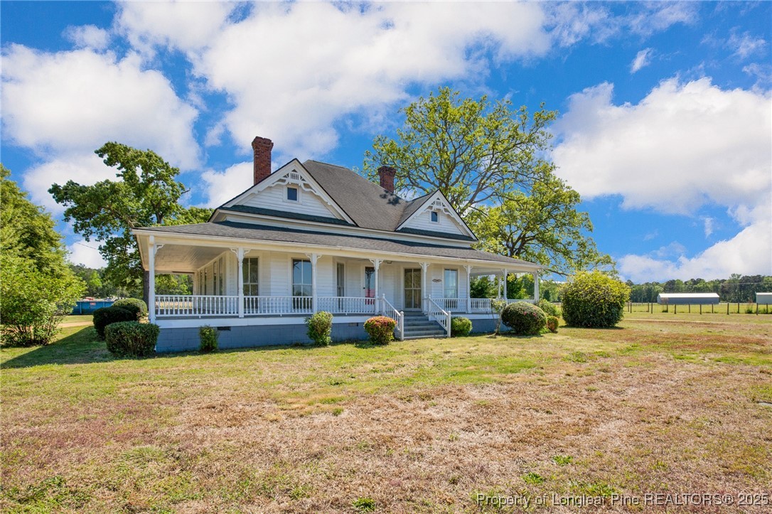 5125 Maxwell Road Autryville, NC 28318 - Photo 3 of 37 a front view of a house with a yard and potted plants