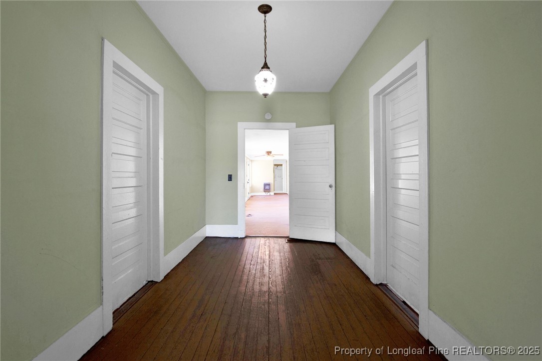 5125 Maxwell Road Autryville, NC 28318 - Photo 6 of 37 a view of a hallway with wooden floor and a chandelier