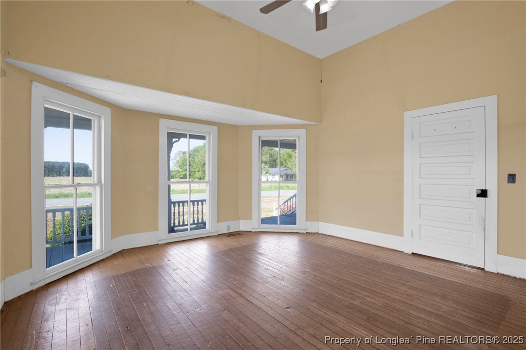 5125 Maxwell Road Autryville, NC 28318 - Photo 10 of 37 a view of an empty room with wooden floor and a window