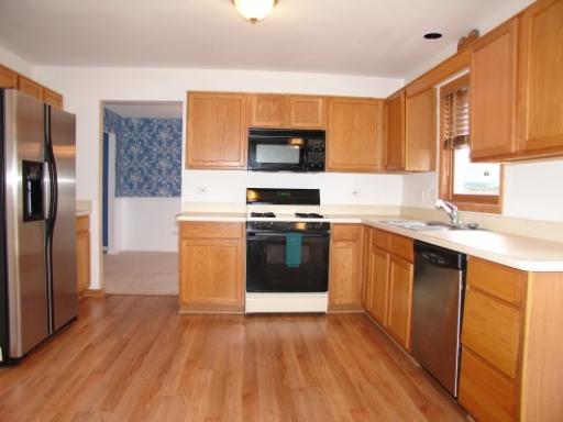 3149 Compton Road Aurora, IL 60504 - Photo 1 of 1 a kitchen with stainless steel appliances a stove a sink and a refrigerator