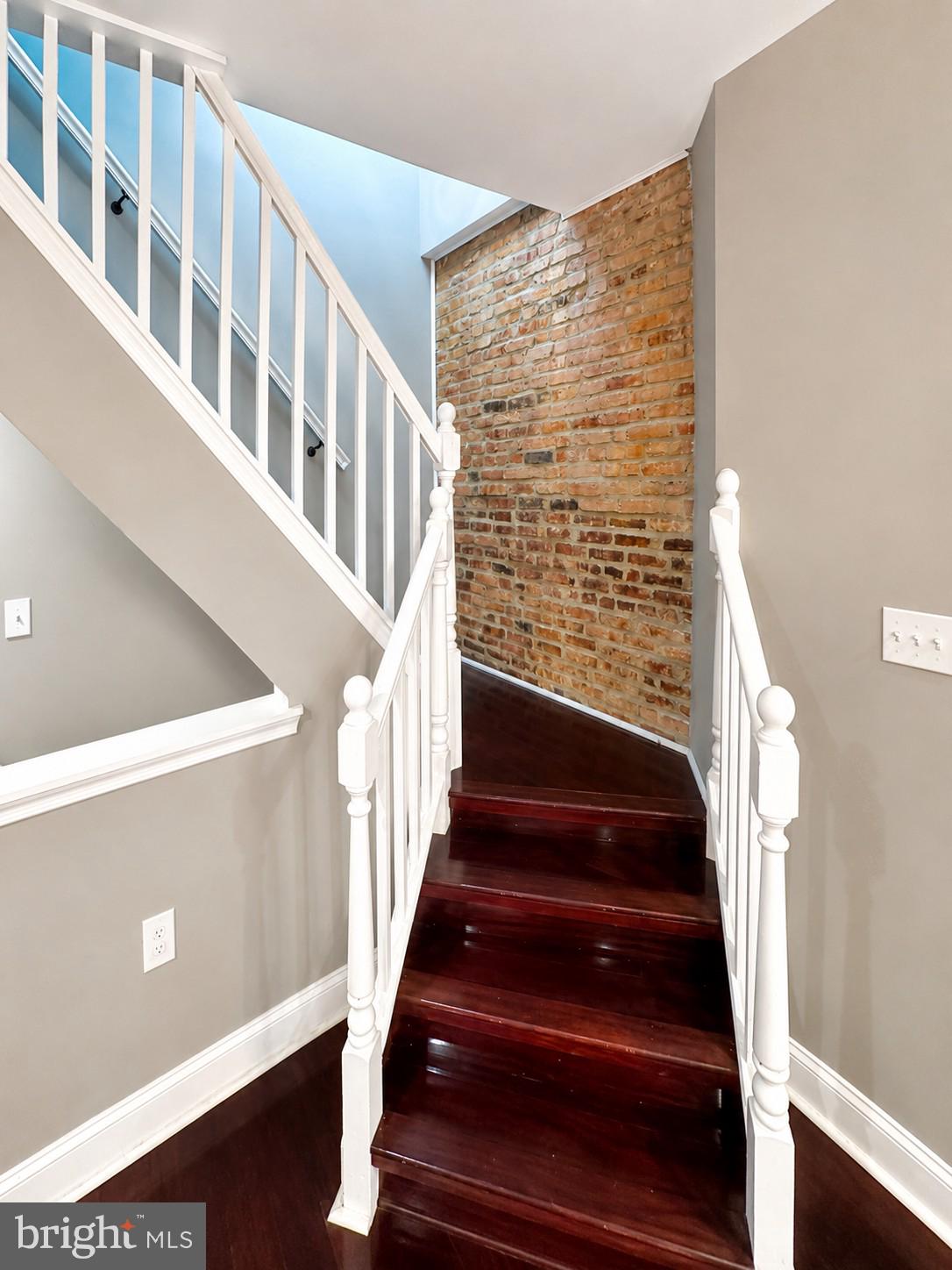 1610 Federal Street Baltimore, MD 21213 - Photo 9 of 27 Elegant staircase with exposed brick.