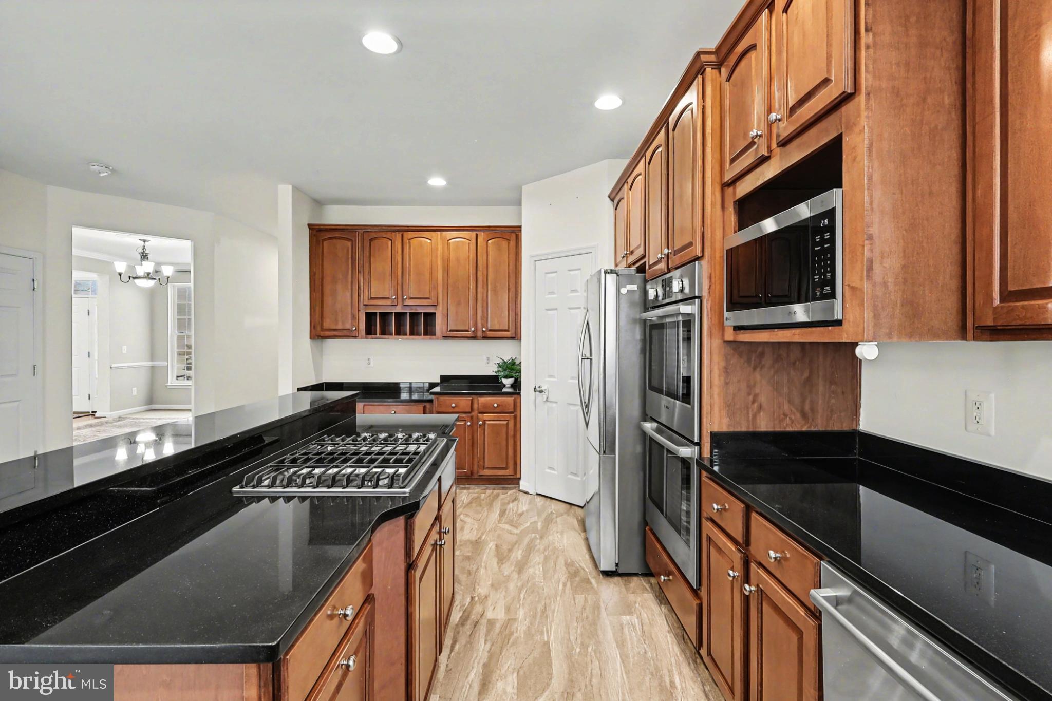 19201 Buna Street Triangle, VA 22172 - Photo 21 of 69 Sleek kitchen with rich wood cabinetry.