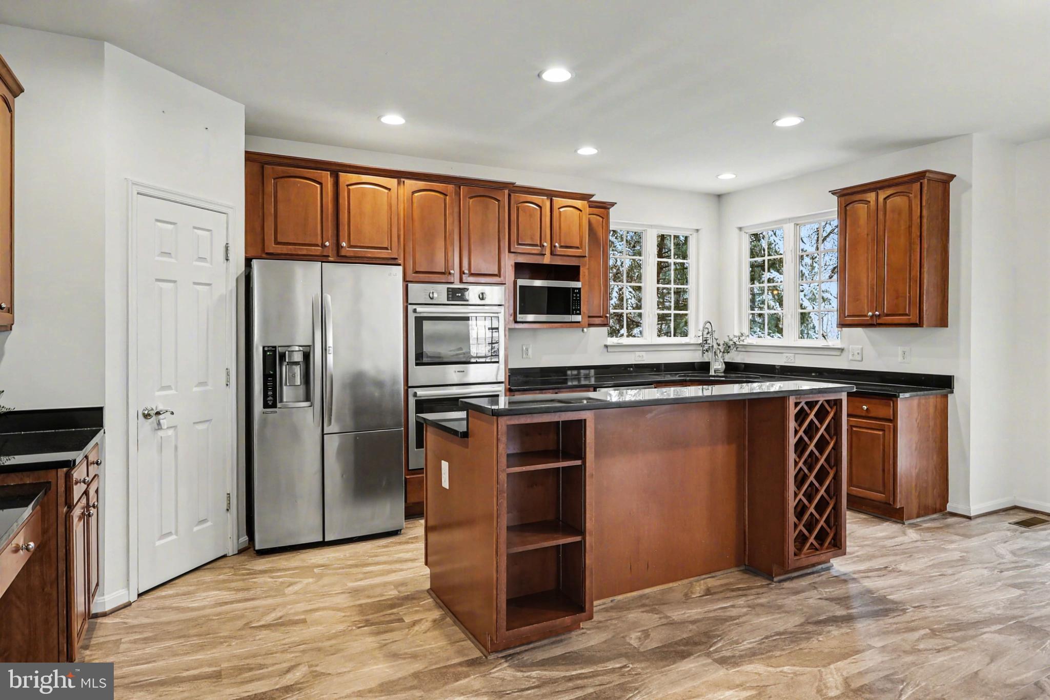 19201 Buna Street Triangle, VA 22172 - Photo 23 of 69 Modern kitchen with rich wood cabinetry.