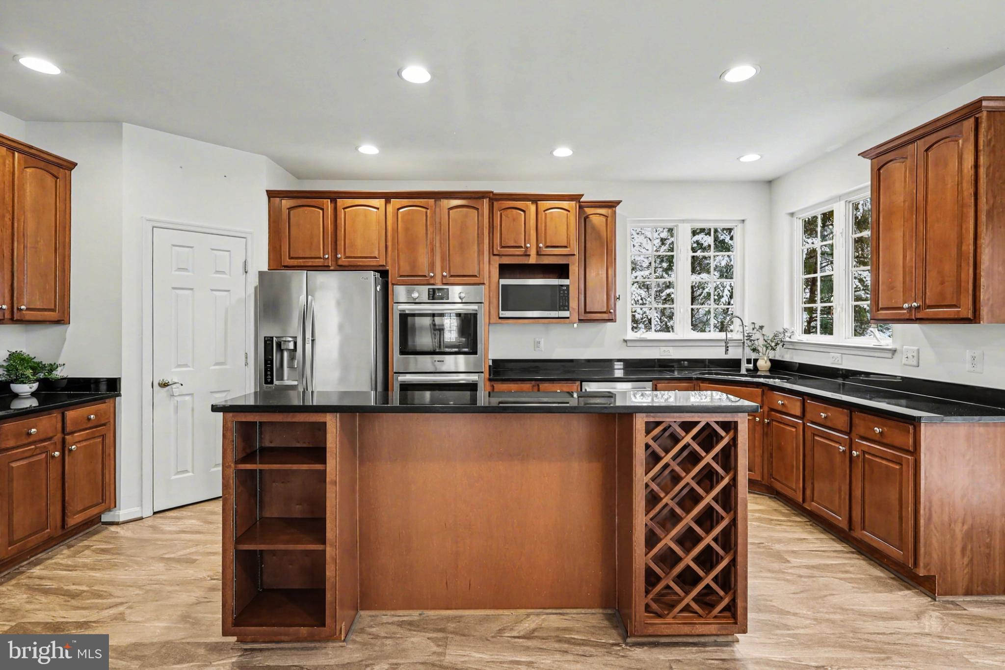 19201 Buna Street Triangle, VA 22172 - Photo 24 of 69 Modern kitchen with rich wood cabinetry.