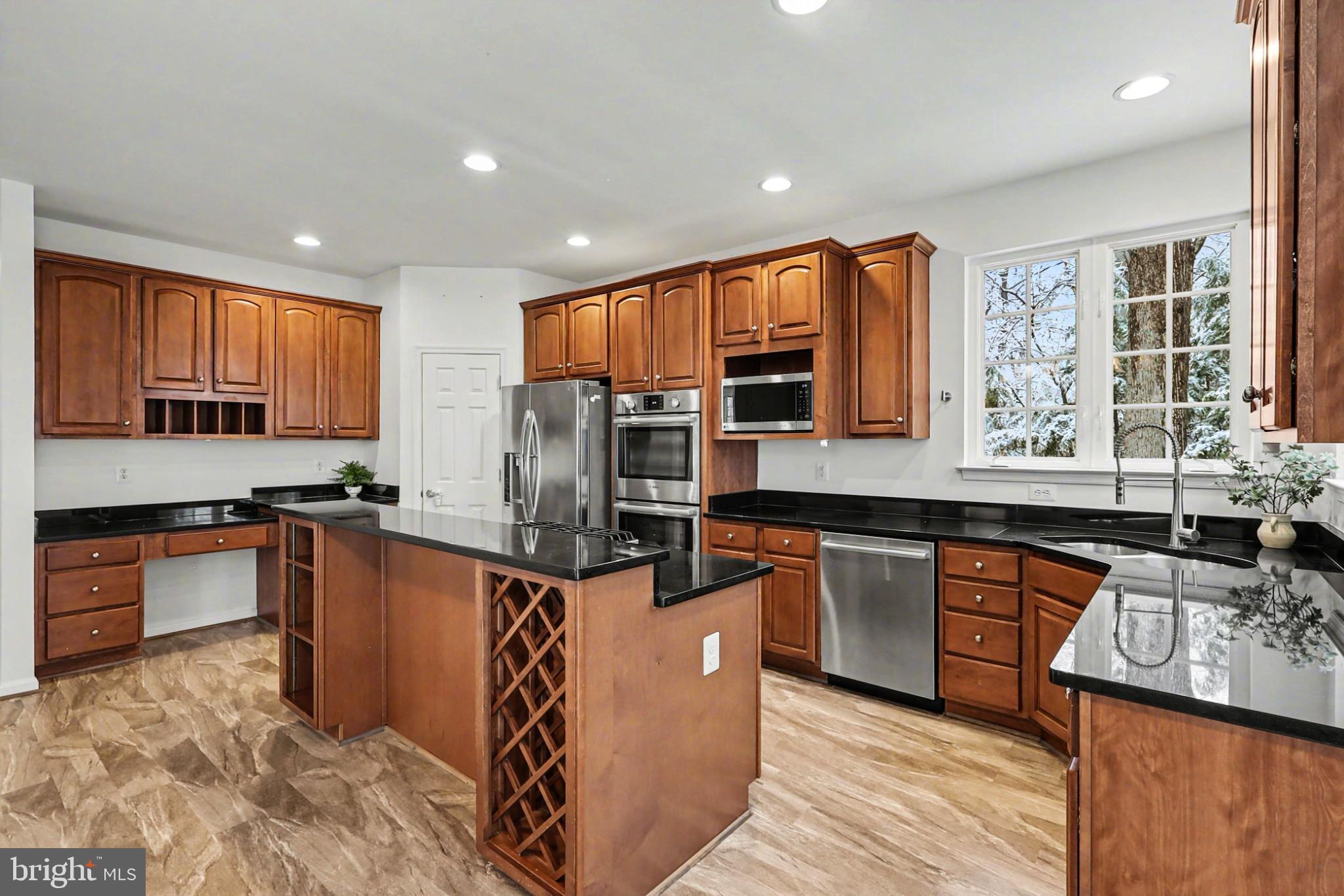 19201 Buna Street Triangle, VA 22172 - Photo 5 of 69 Modern kitchen with rich wood cabinetry.