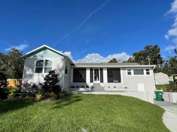 a front view of house with yard and green space
