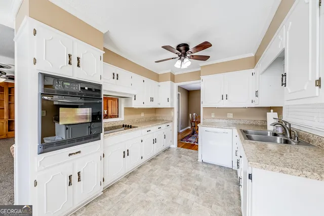 a kitchen with granite countertop a stove a sink and a microwave