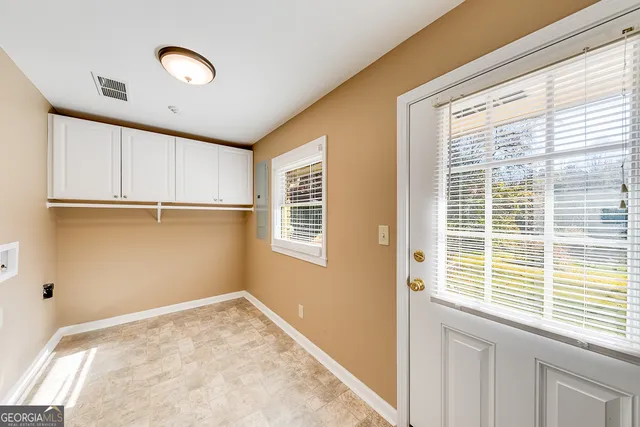 a view of a kitchen with wooden floor and a window