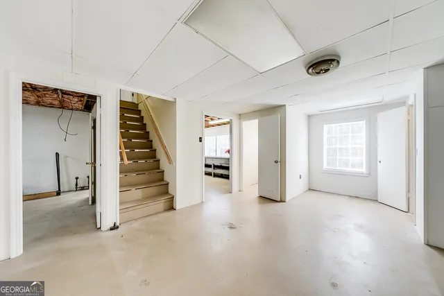 a view of an empty room with a fireplace and a window