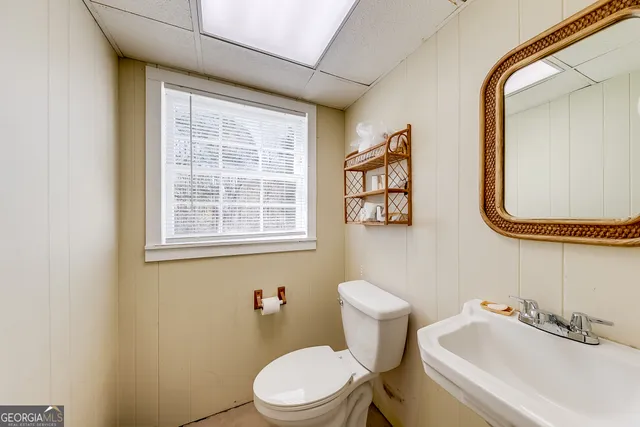 a white toilet sitting next to a bathroom sink