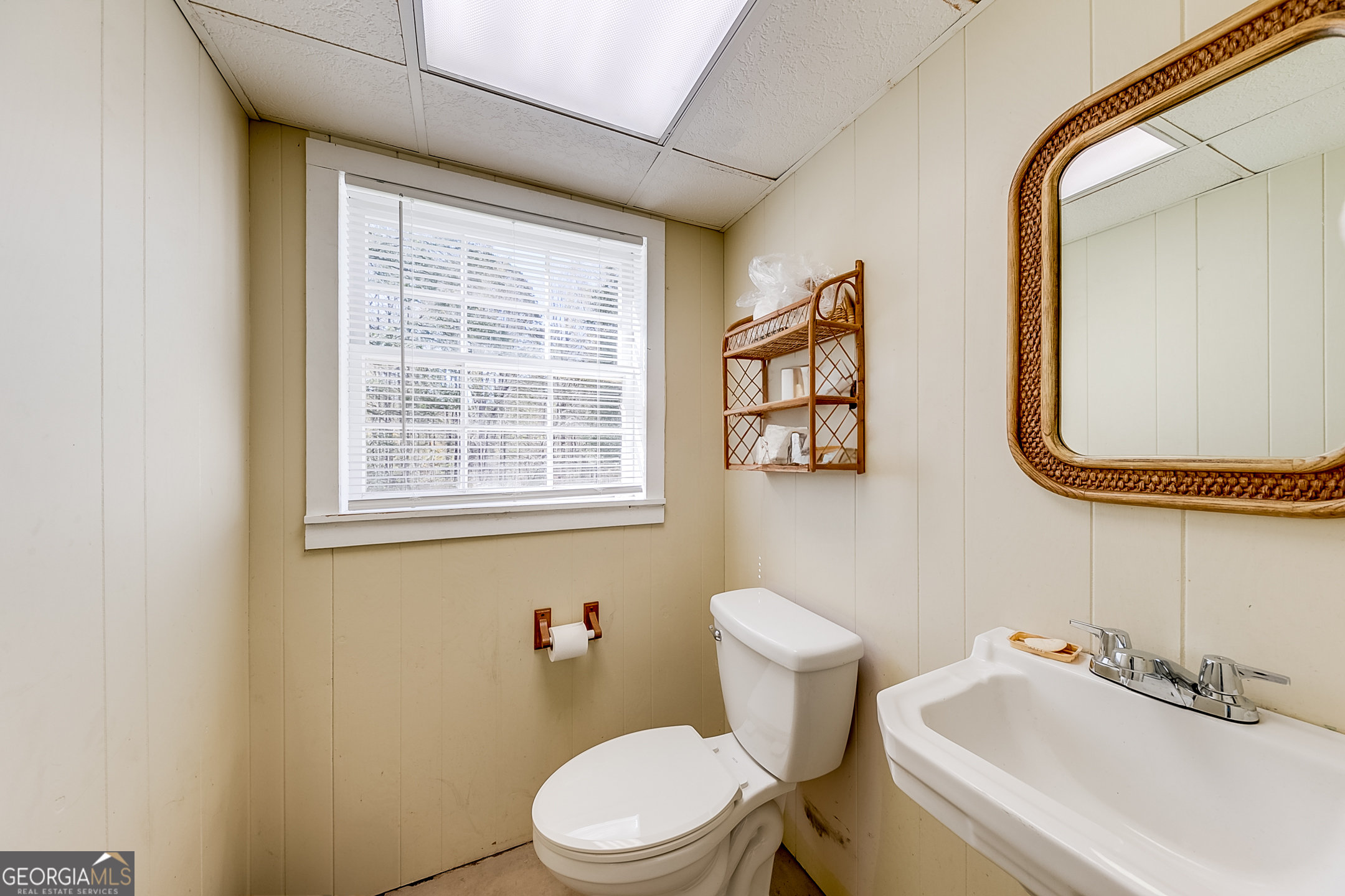 1174 Hospital Road Commerce, GA 30529 - Photo 24 of 40 a white toilet sitting next to a bathroom sink