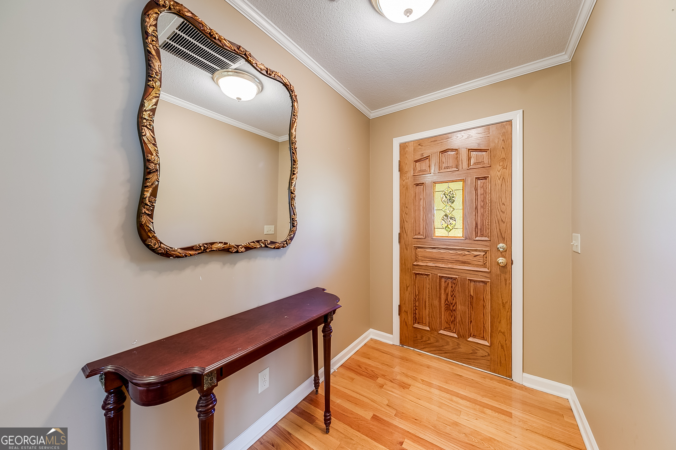 1174 Hospital Road Commerce, GA 30529 - Photo 6 of 40 a room with a mirror and a wooden floor