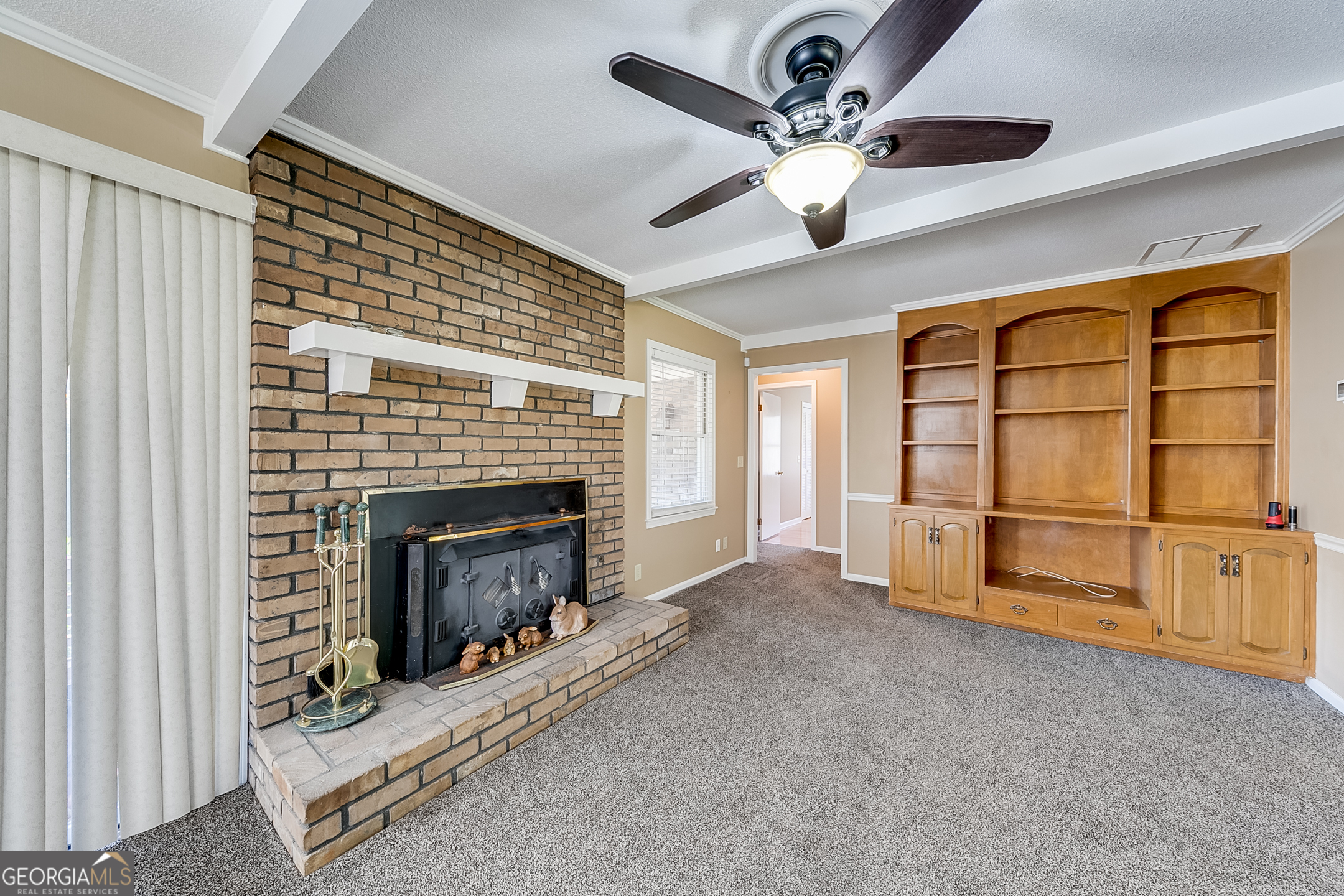 1174 Hospital Road Commerce, GA 30529 - Photo 8 of 40 a living room with furniture a fireplace and a ceiling fan