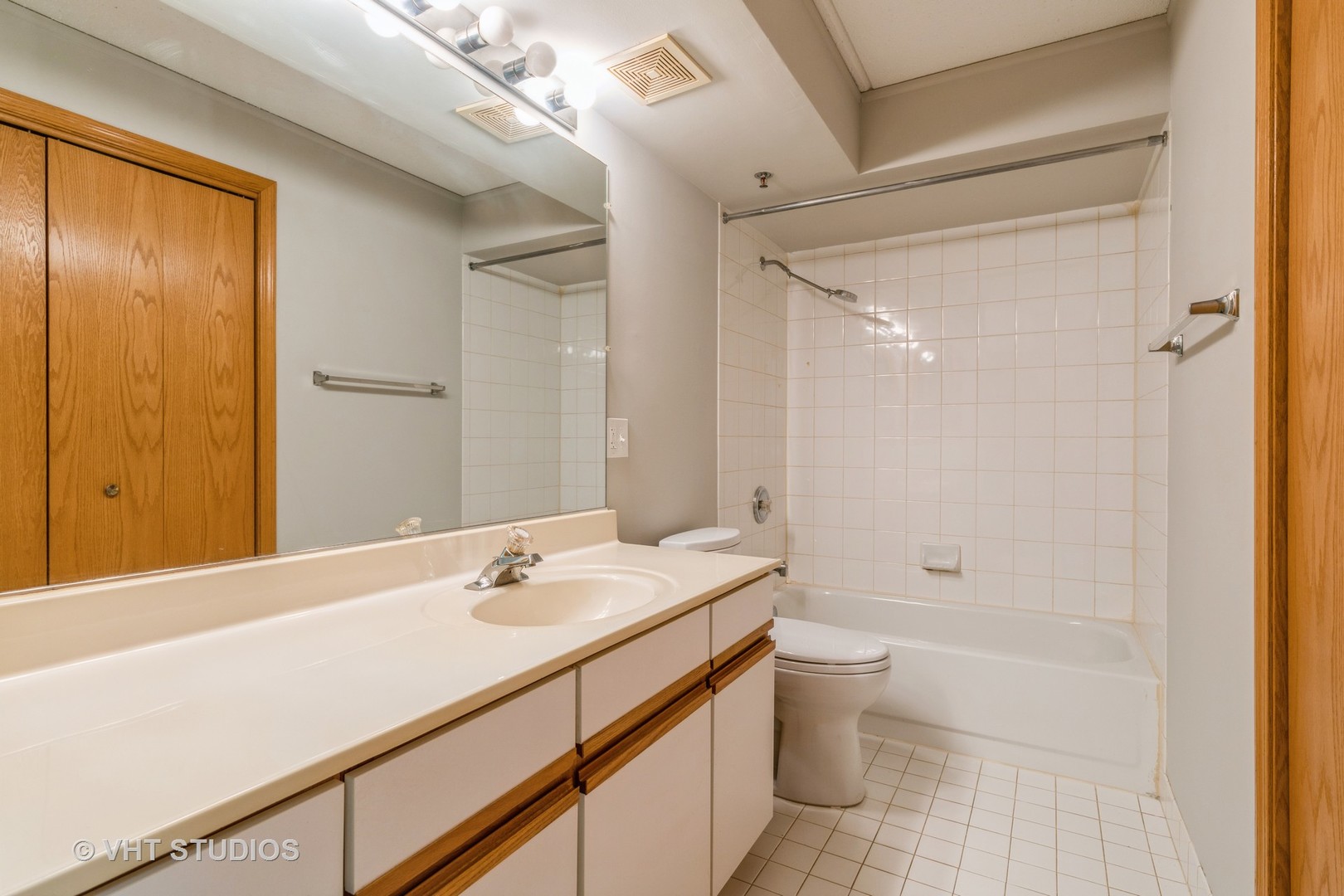 7450 North Waukegan Road, Unit 405 Niles, IL 60714 - Photo 11 of 15 a bathroom with a sink a toilet and shower