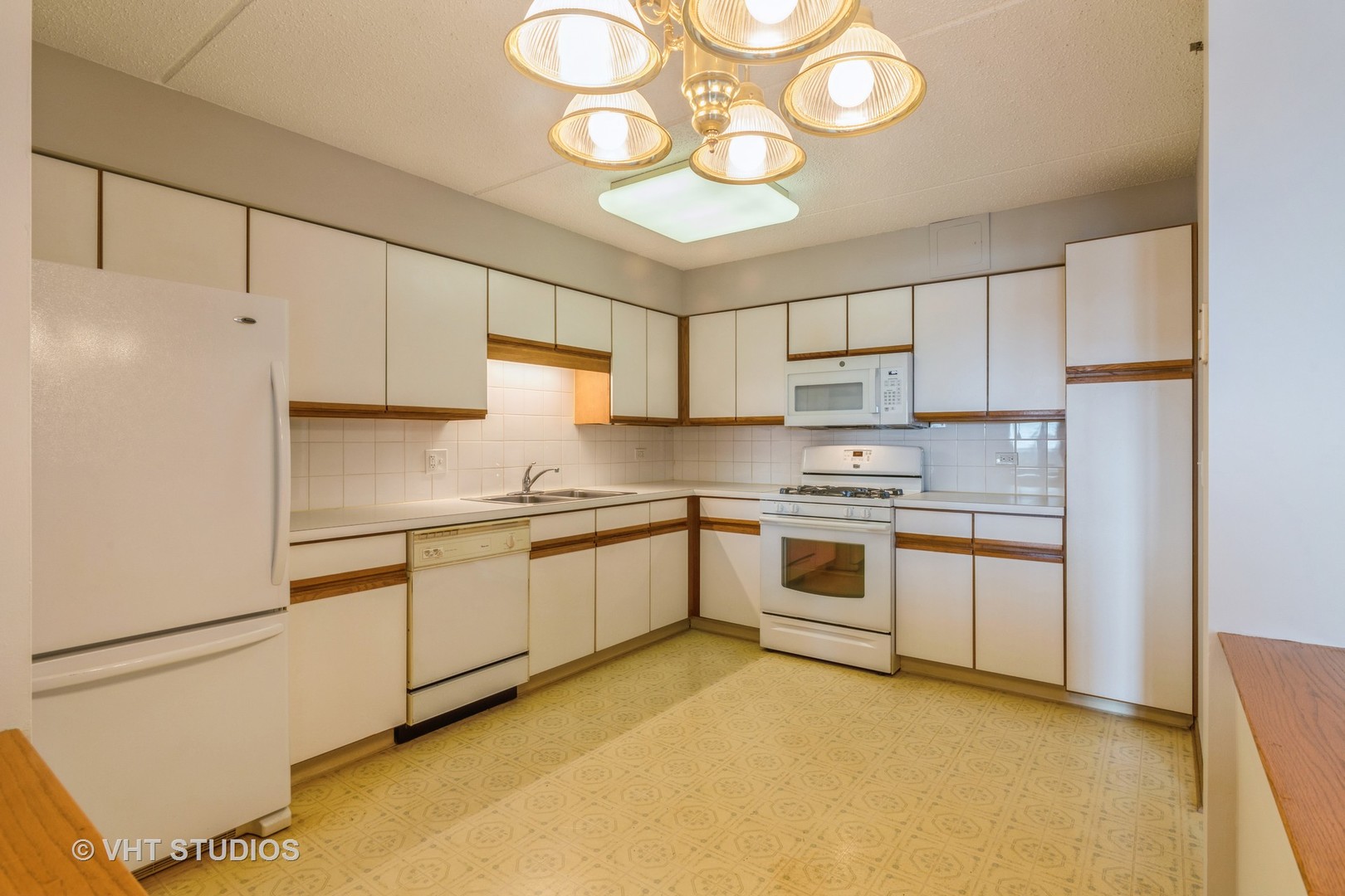 7450 North Waukegan Road, Unit 405 Niles, IL 60714 - Photo 5 of 15 a kitchen with stainless steel appliances granite countertop a sink a stove a refrigerator and white cabinets