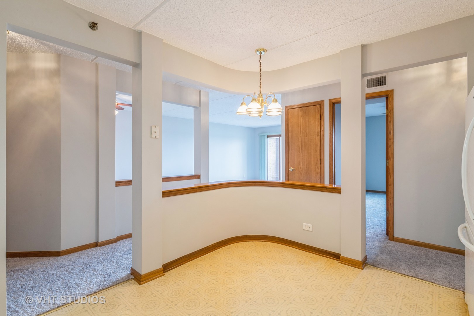 7450 North Waukegan Road, Unit 405 Niles, IL 60714 - Photo 6 of 15 a view of an empty room with window and chandelier fan