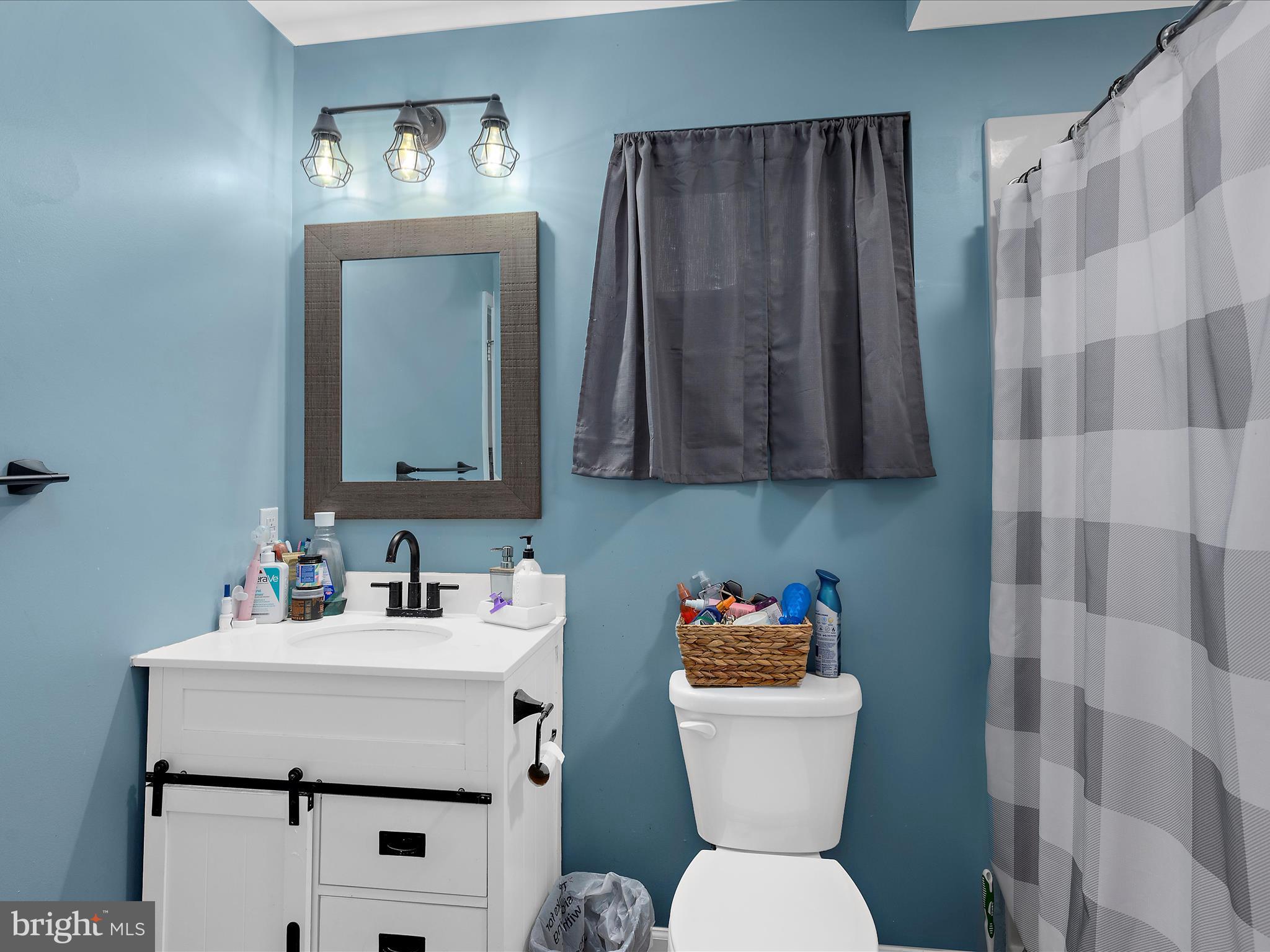 249 Double Oak Road Prince Frederick, MD 20678 - Photo 24 of 30 a bathroom with a toilet sink and mirror
