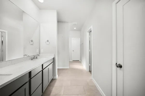 a bathroom with a double vanity sink and a mirror