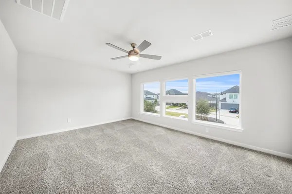 an empty room with closet and windows