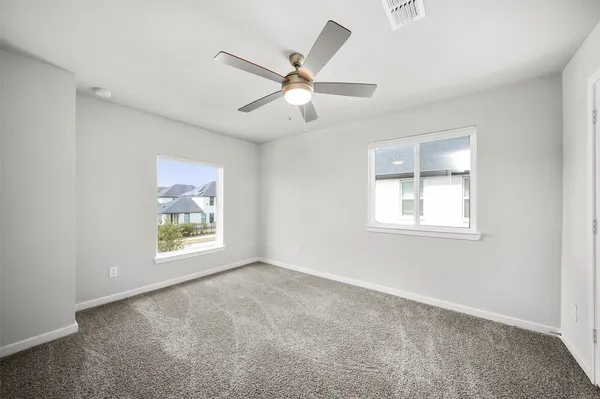 a bathroom with a bathtub shower sink vanity mirror and toilet