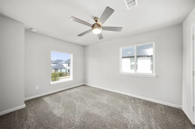 a bathroom with a bathtub shower sink vanity mirror and toilet